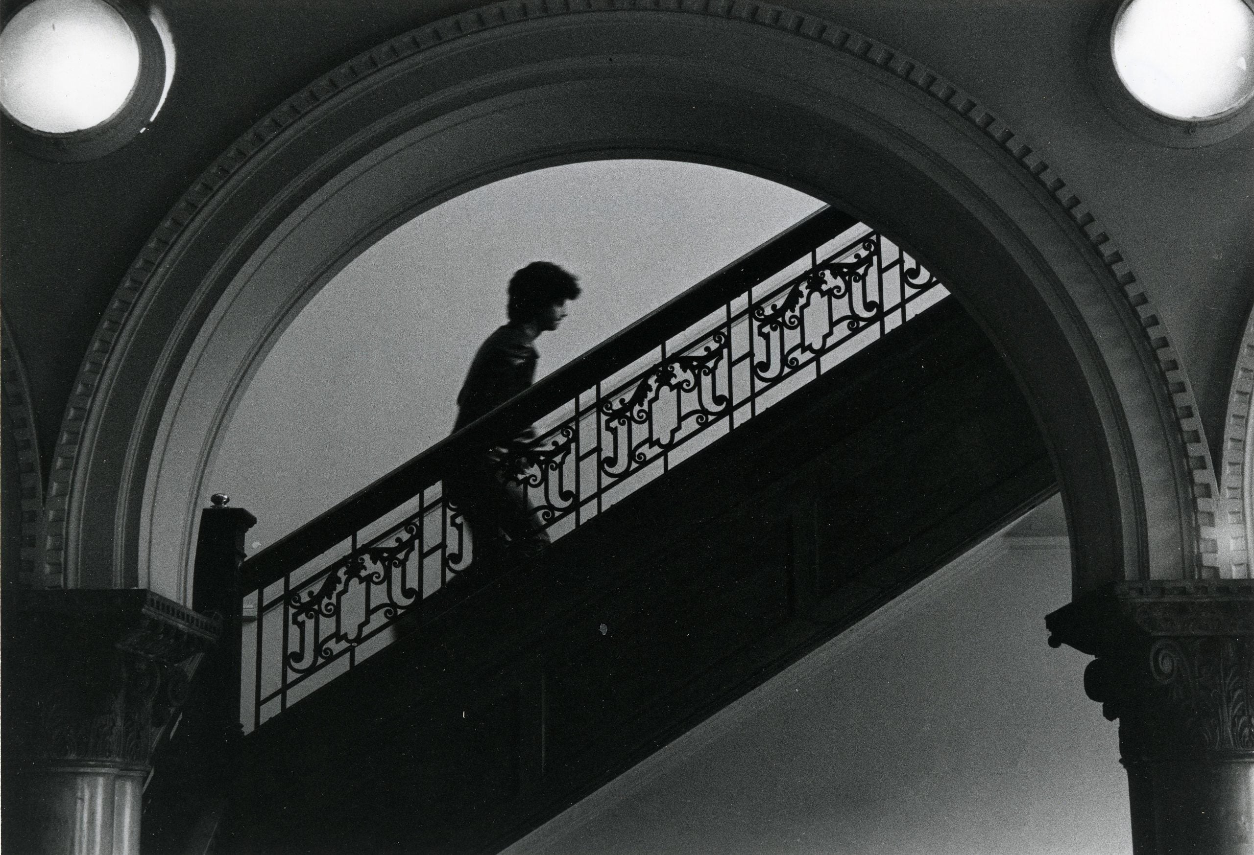 Photograph of student walking up staircase in the Pratt Institute Library