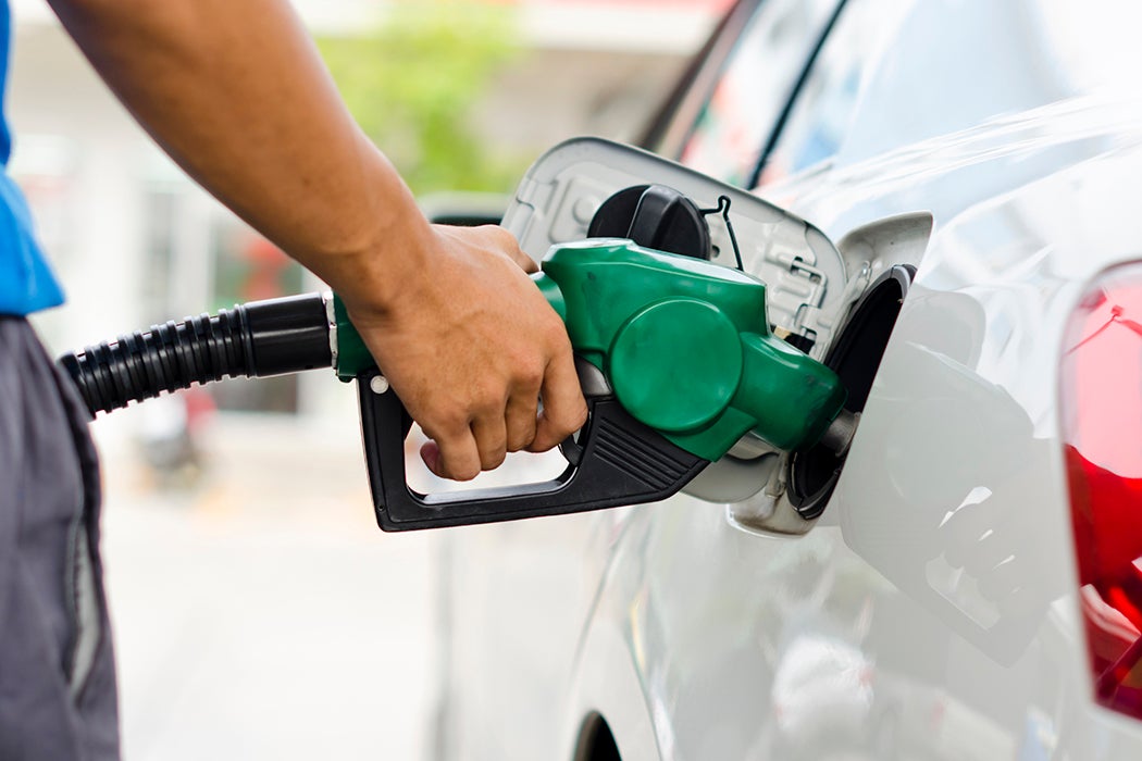 Refueling Car With Gasoline Pump Nozzle, Selective Focus on pump nozzle