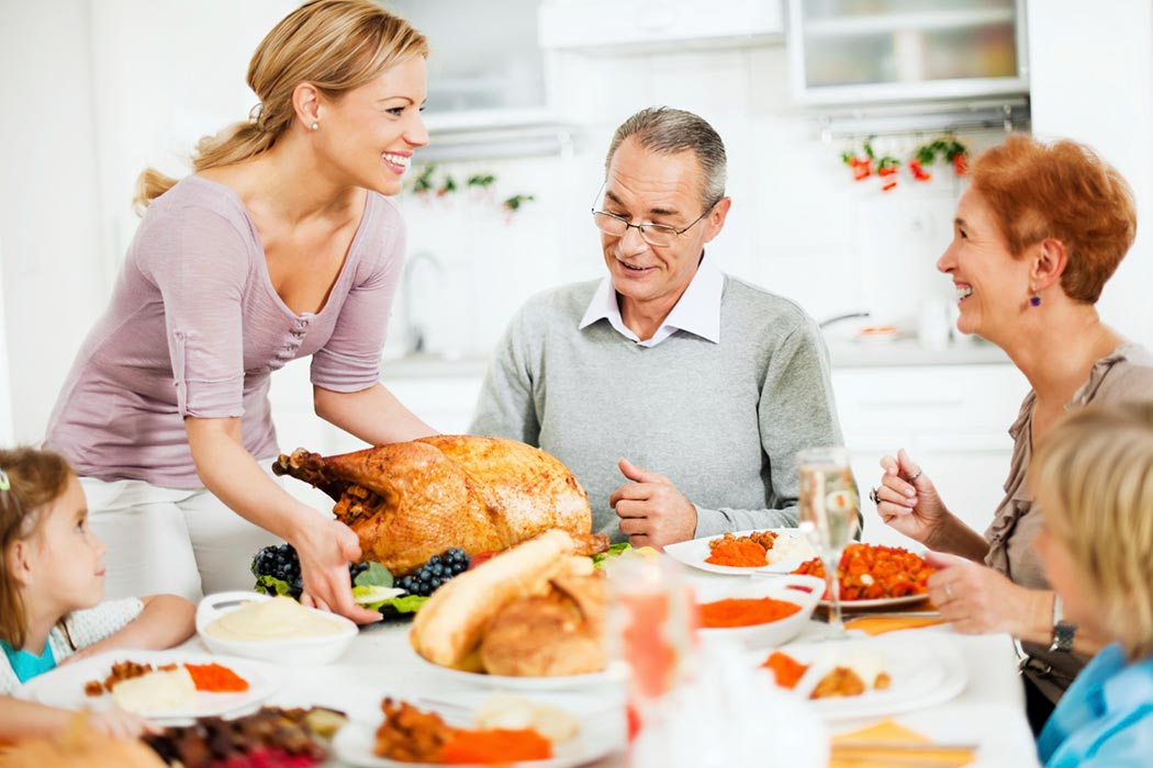 A family gathers around the table for Thanksgiving