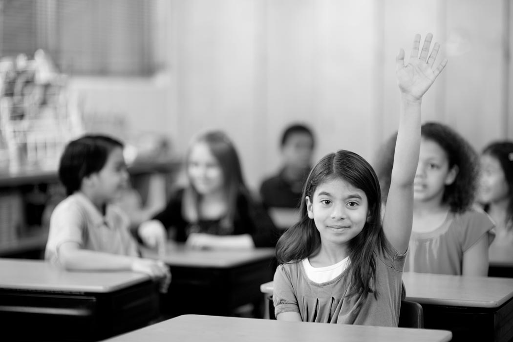 A student in the front row raises her hand