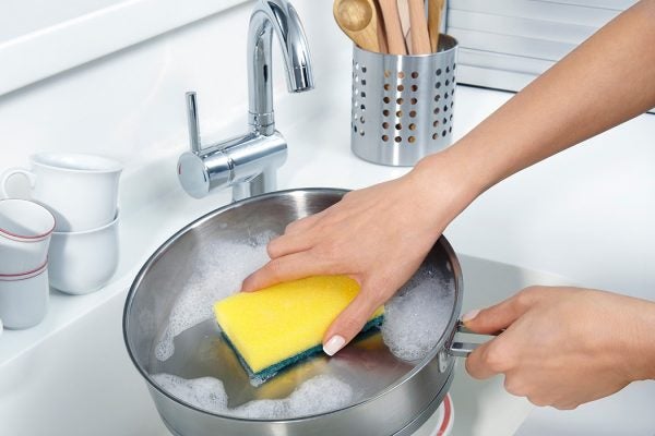 A pot being washed in a sink