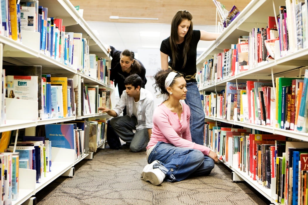 Students looking for books in a school library