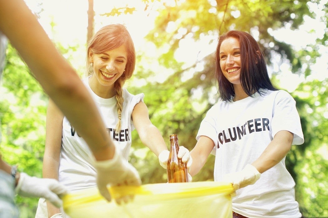 Volunteers happily clean up a park