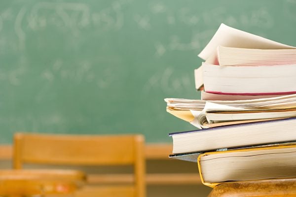 Pile of textbooks on a desk