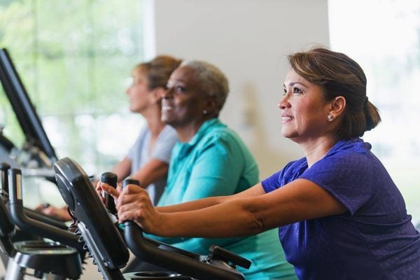 A women riding an exercise bikes at the gym.