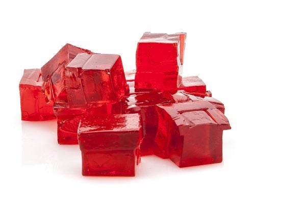 Cubes of red jello on white background