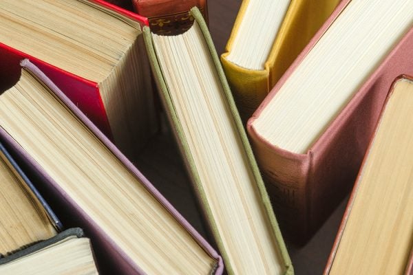 a stack of colorful books in a library