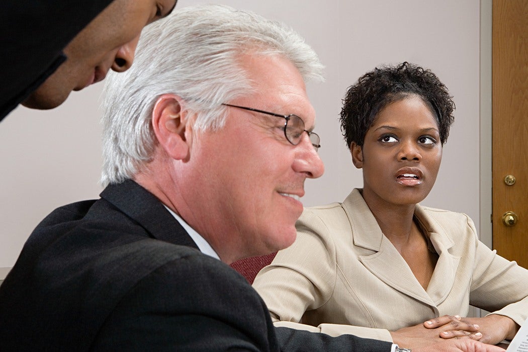 Woman looking at men whispering