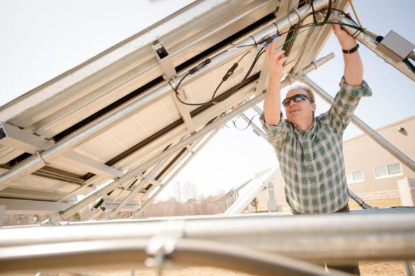 Joshua Pearce positioning a solar panel