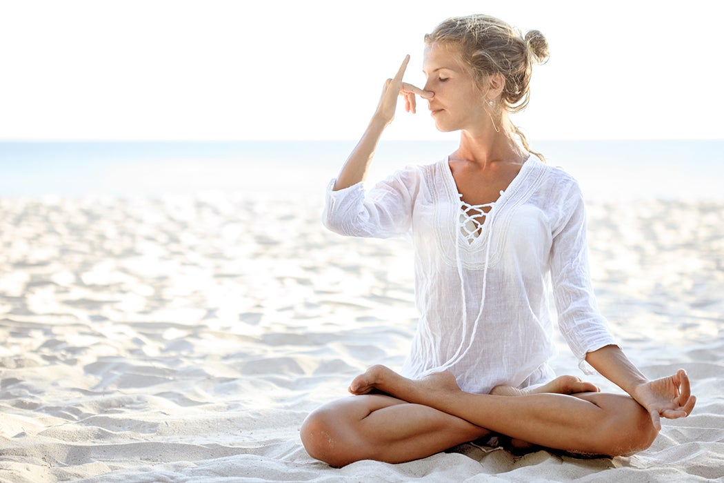 Woman doing yoga on beach