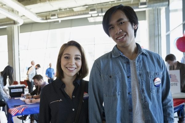 Portrait young couple at voter polling place