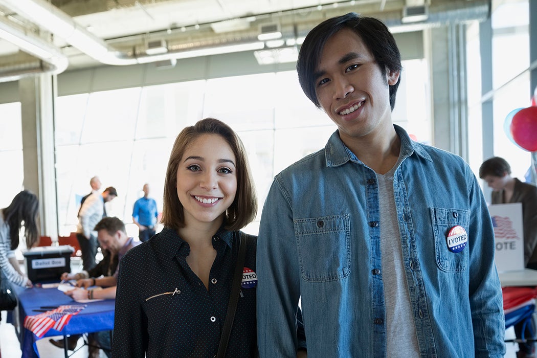 Portrait young couple at voter polling place