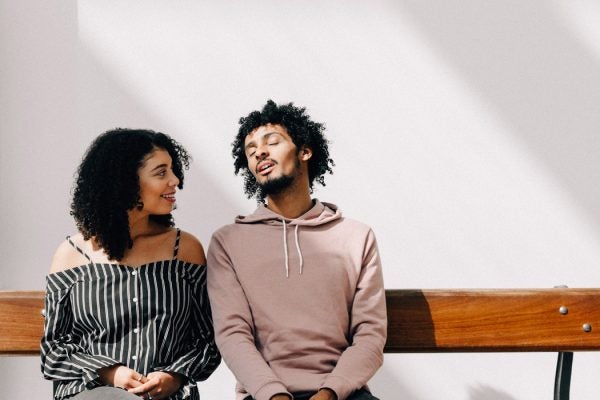 A couple sitting on a bench and talking