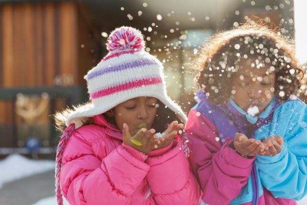 Two children playing in the snow