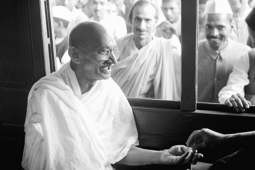 Mahatma Gandhi receiving a donation in a train compartment, 1940