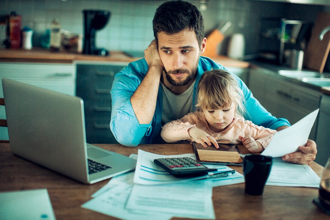 A man with his daughter paying a bill