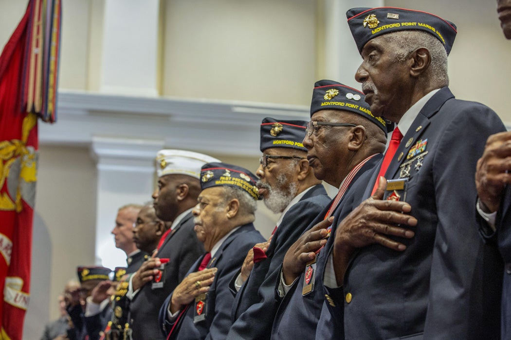 Montford Point Marines stand for the national anthem during an evening parade at Marine Barracks Washington in Washington, D.C., June 16, 2017.