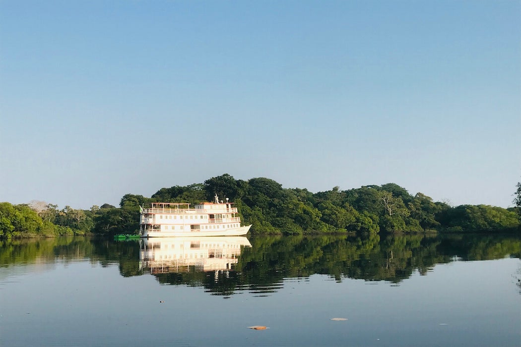 A solar-panel equipped ship moves down the Amazon River