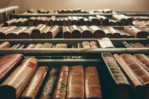 A tall bookcase of old books