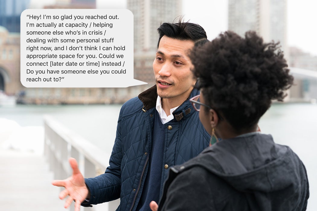 A man and a woman talking, with the city of Boston's skyline in the background.