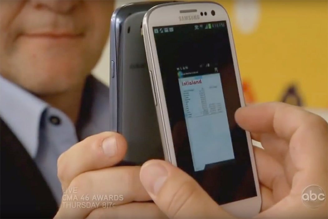 A man holding a cell phone against a mirror