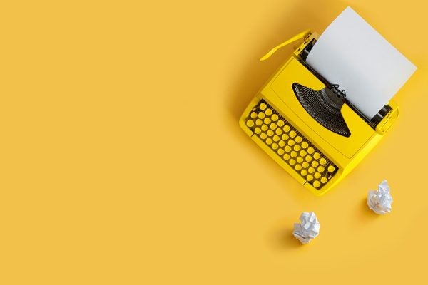 A typewriter on a yellow background