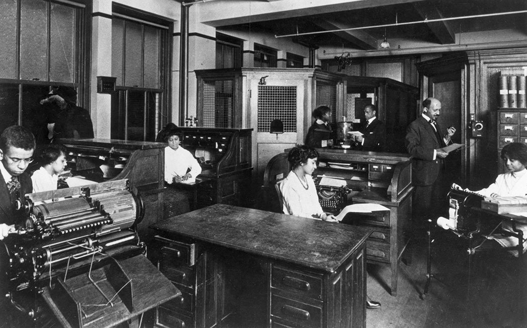 W E B Du Bois (right) at the headquarters of the NAACP publication 'Crisis' as his production staff work at their desks, c. 1932