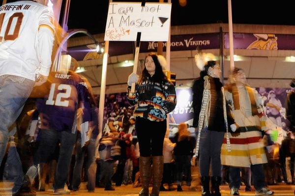 Raven Ziegler from Minneapolis protests the name of the Washington Redskins before a game on November 7, 2013