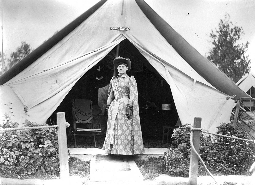 Annie Oakley in front of her tent, 1889