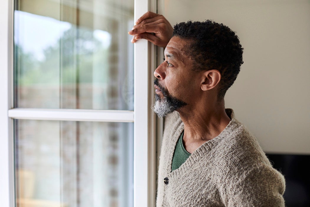 Pensive man looking out of window