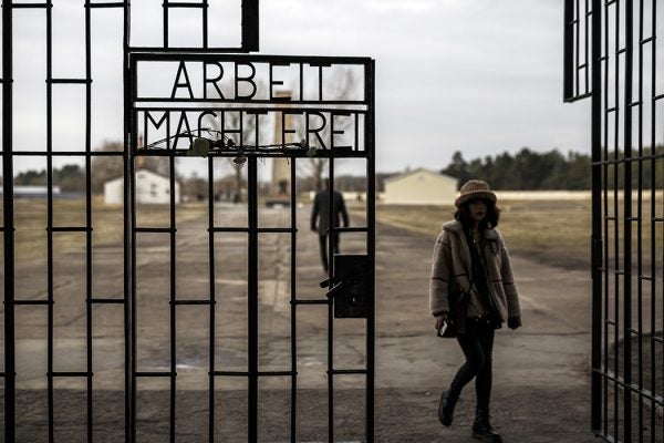 Visitors walk past the entrance gate to the Auschwitz death camp, the most notorious of the many Nazi concentration camps