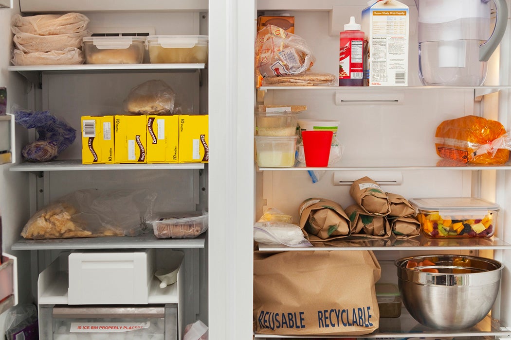 Stacked products in open fridge