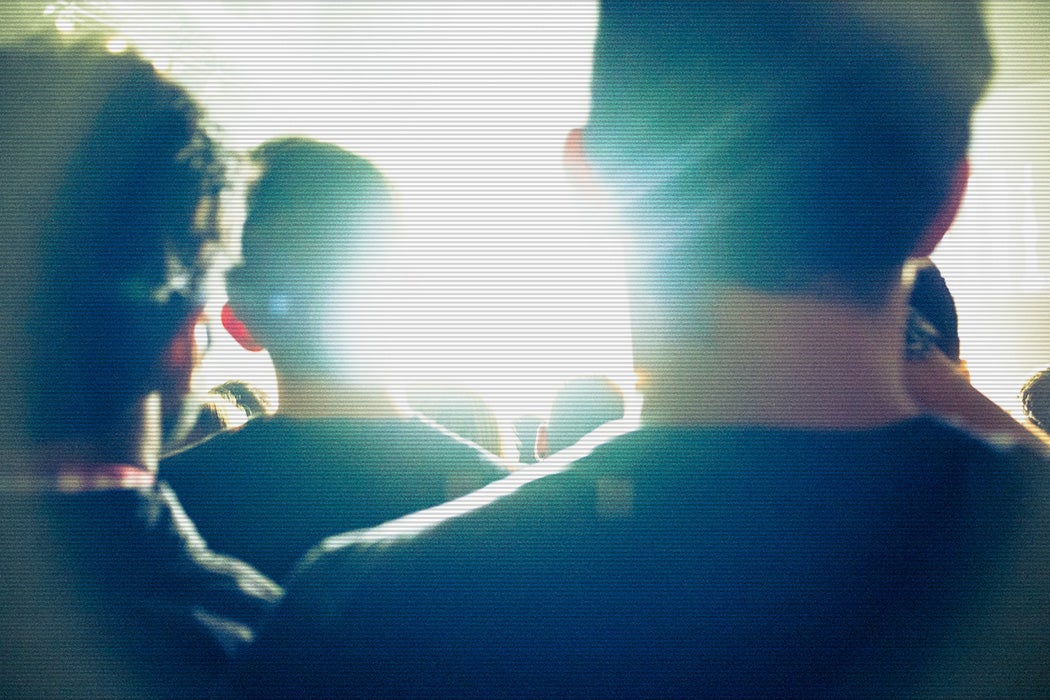 People standing in a group looking into the light