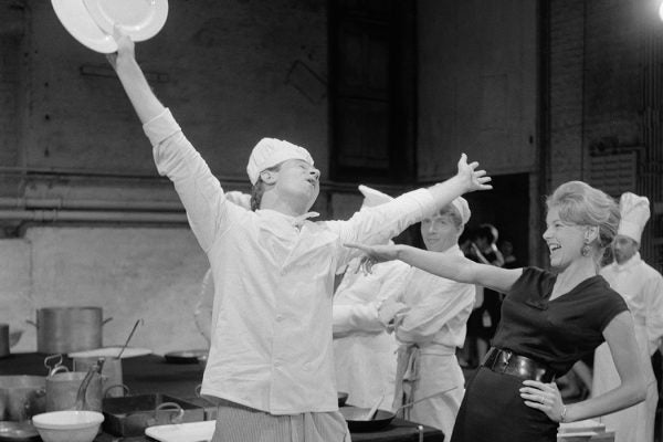 Actors Robert Stephens (1931 - 1995) as a cook and Mary Peach as waitress Monique during rehearsals for the play 'The Kitchen' by Arnold Wesker at the Royal Court Theatre in London, 27th June 1961.