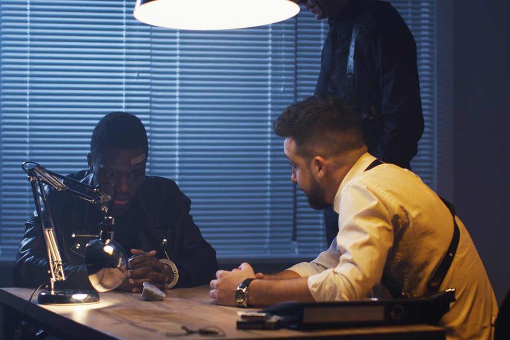 Two policemen interrogating somebody