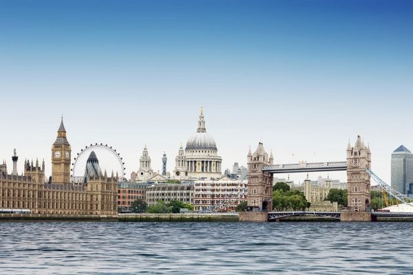 London montage against plain blue sky with River Thames in foreground