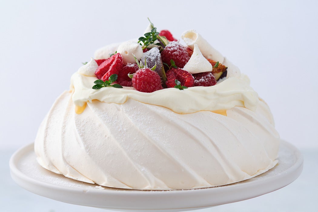 Pavlova cake on a white background