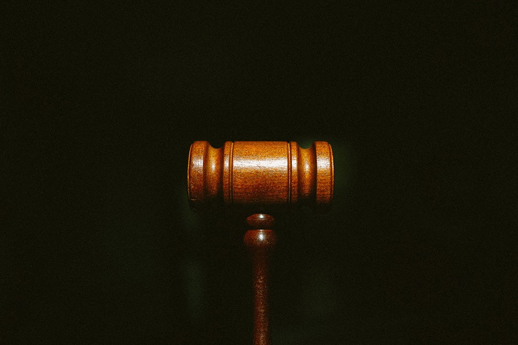 A gavel against a black background