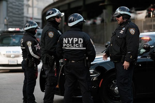 Police officers gather as the body of NYPD officer Wilbert Mora is transferred in an ambulance from NYU Langone Hospital to a Medical Examiner's office at the same location on January 25, 2022 in New York City.