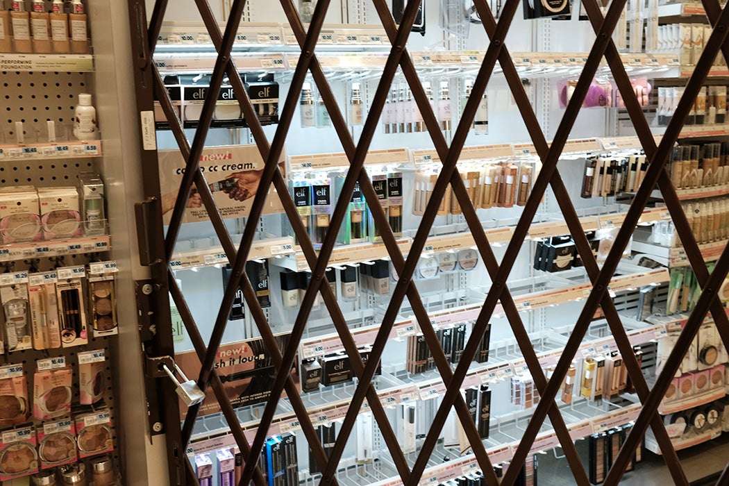 A gate is used to lock items at a pharmacy and convenience store on October 26, 2021 in New York City