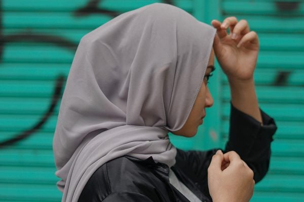 A woman wearing a head scarf