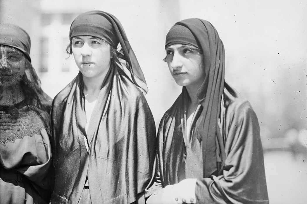 Turkish women waiting outside a mosque for friends before going in to pray, 1920