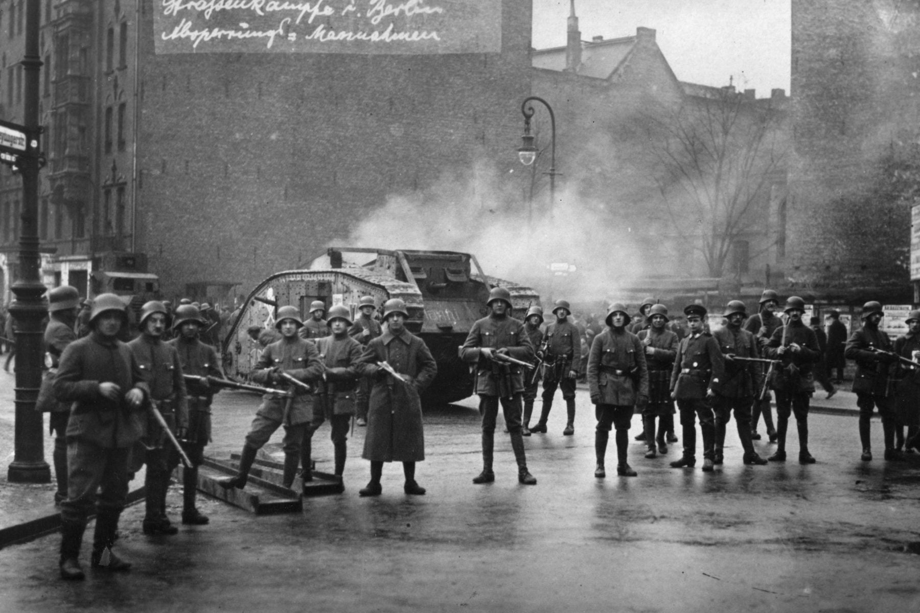 Germain soldiers holding the perimeter around a tank during a time of political unrest during the Weimar Era.