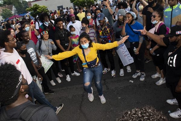 Onlookers watch as people dance at a memorial site for George Floyd outside Cup Foods June 5, 2020 in Minneapolis, Minnesota