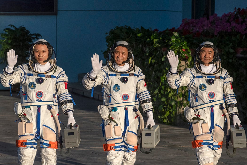 Chinese astronauts from China's Manned Space Agency, left to right, Tang Hongbo, Nie Haisheng, and Liu Boming wave at a departure ceremony before launch of the Senzhou-12 at the Jiuquan Satellite Launch Center on June 17, 2021 in Jiuquan, Gansu province, China.