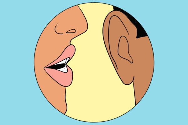 A woman's mouth whispering into a man's ear.