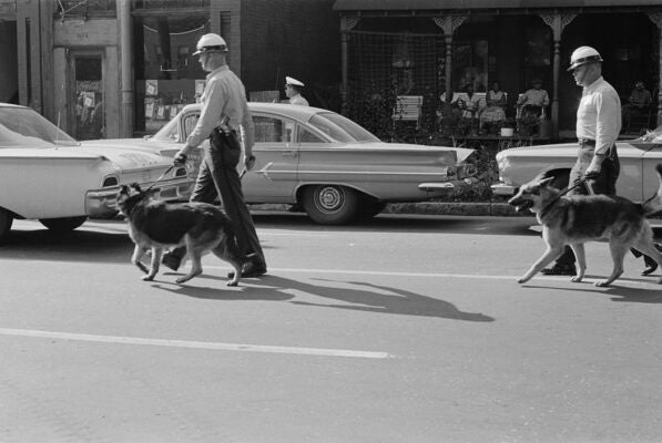 Police officers patrolling the streets at the start of the Birmingham Campaign in Birmingham, Alabama, May 1963.