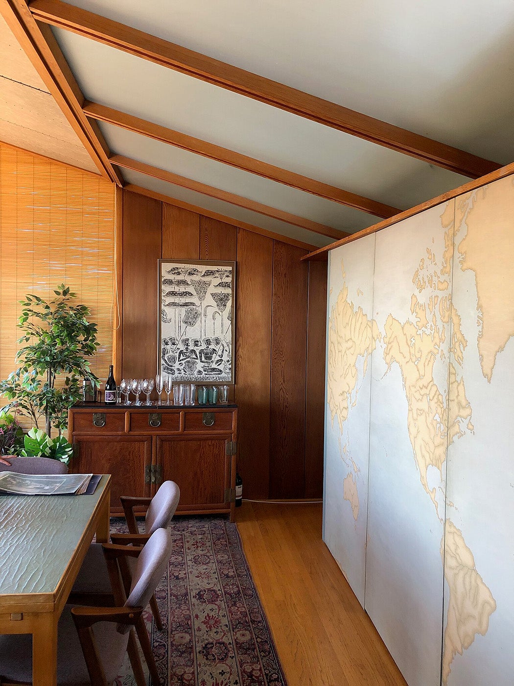 In the Weston Havens House in Berkeley, California, this is the dining room area, with a painted divider (in the style of a map) that separates this room from the kitchen.