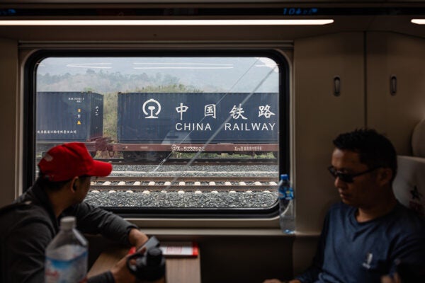 LUANG PRABANG, LAOS - APRIL 09: The China-Laos Railway passes by a China Railway cargo shipment on April 09, 2024 in Luang Prabang, Laos. The China-Laos railway, a key project of China's Belt and Road Initiative, is a high-speed railway connecting Kunming, the capital of China's Yunnan province, to Vientiane, the capital of Laos. This railway is the biggest public infrastructure project ever undertaken by Laos, with a total length of 1,035 kilometers and a cost of US$5.9 billion, which is equivalent to around one-third of Laos' gross domestic product in 2019. The railway is dedicated to both passenger and freight traffic services, creating a new link between Laos and China, the former's neighbor and closest partner. The Laos section of the railway is part of a vision to build a Pan-Asia railway that will ultimately connect China, Laos, Thailand, Malaysia, and Singapore, improving the efficiency of goods movement for export-driven economies along the route, opening up travel and extending China's influence deep into Southeast Asia. (Photo by Lauren DeCicca/Getty Images)