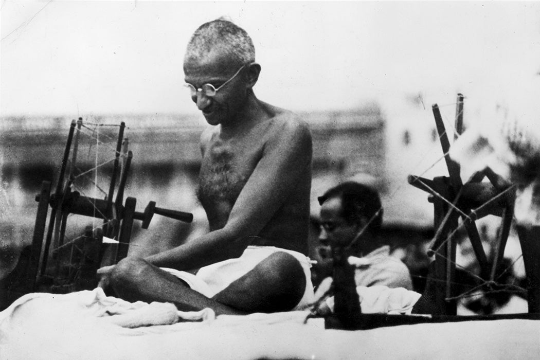 Mahatma Gandhi at a spinning wheel during a 'Charlea' demonstration in Mirzapur, Uttar Pradesh, 1925